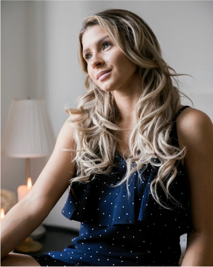 Woman wearing a sophisticated London MP dress in a warm, minimalist setting